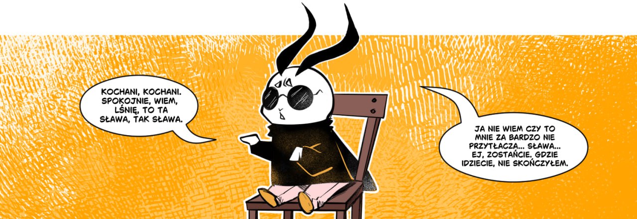 Grafika przedstawia Ioctusia, maskotkę grupy komiksowej Iocte Nocte. Ioctuś siedzi w okularach przeciwsłonecznych na pomarańczowym tle.